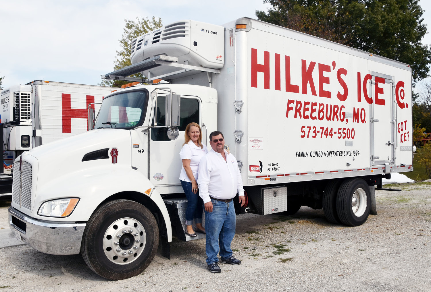 Laron and Donna Hilke stand with one of their many delivery trucks.